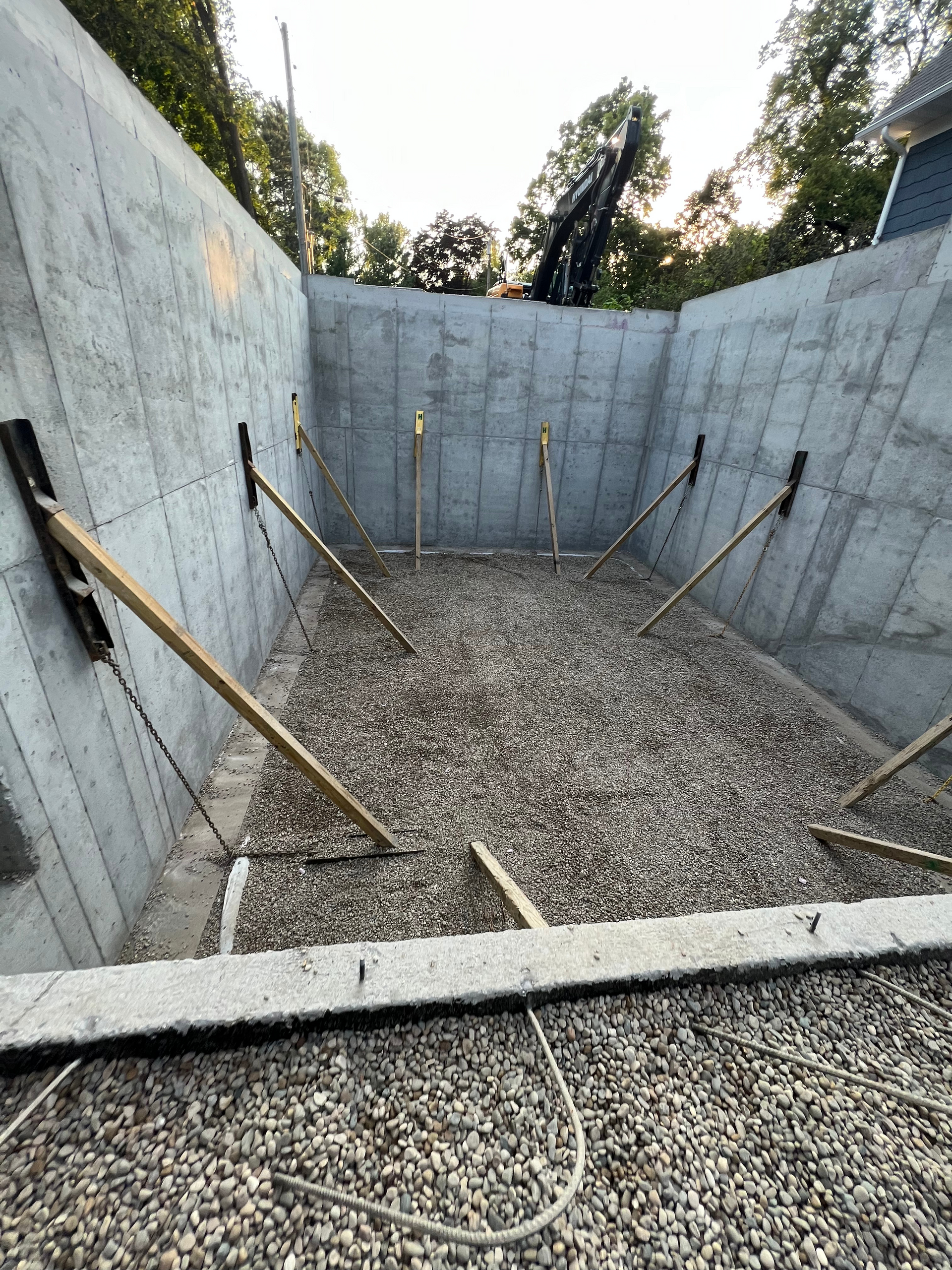 A large concrete wall with a lot of gravel in it.