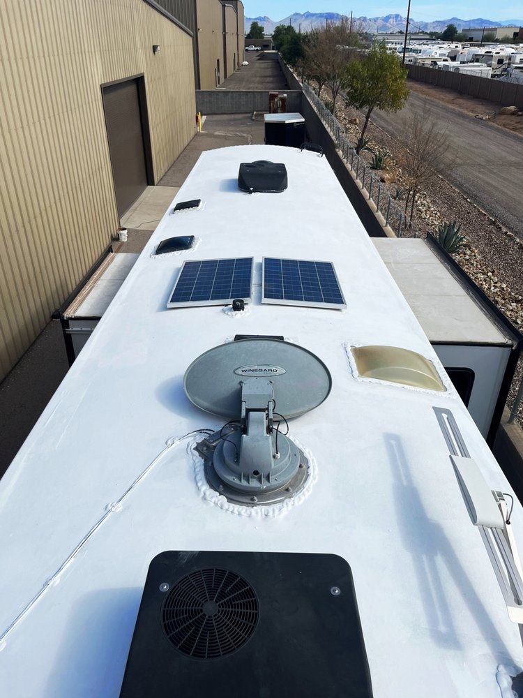 The roof of a bus with solar panels and a fan