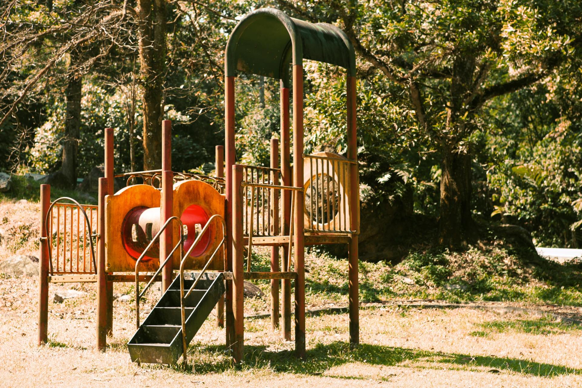 a playground with a slide and stairs in a park