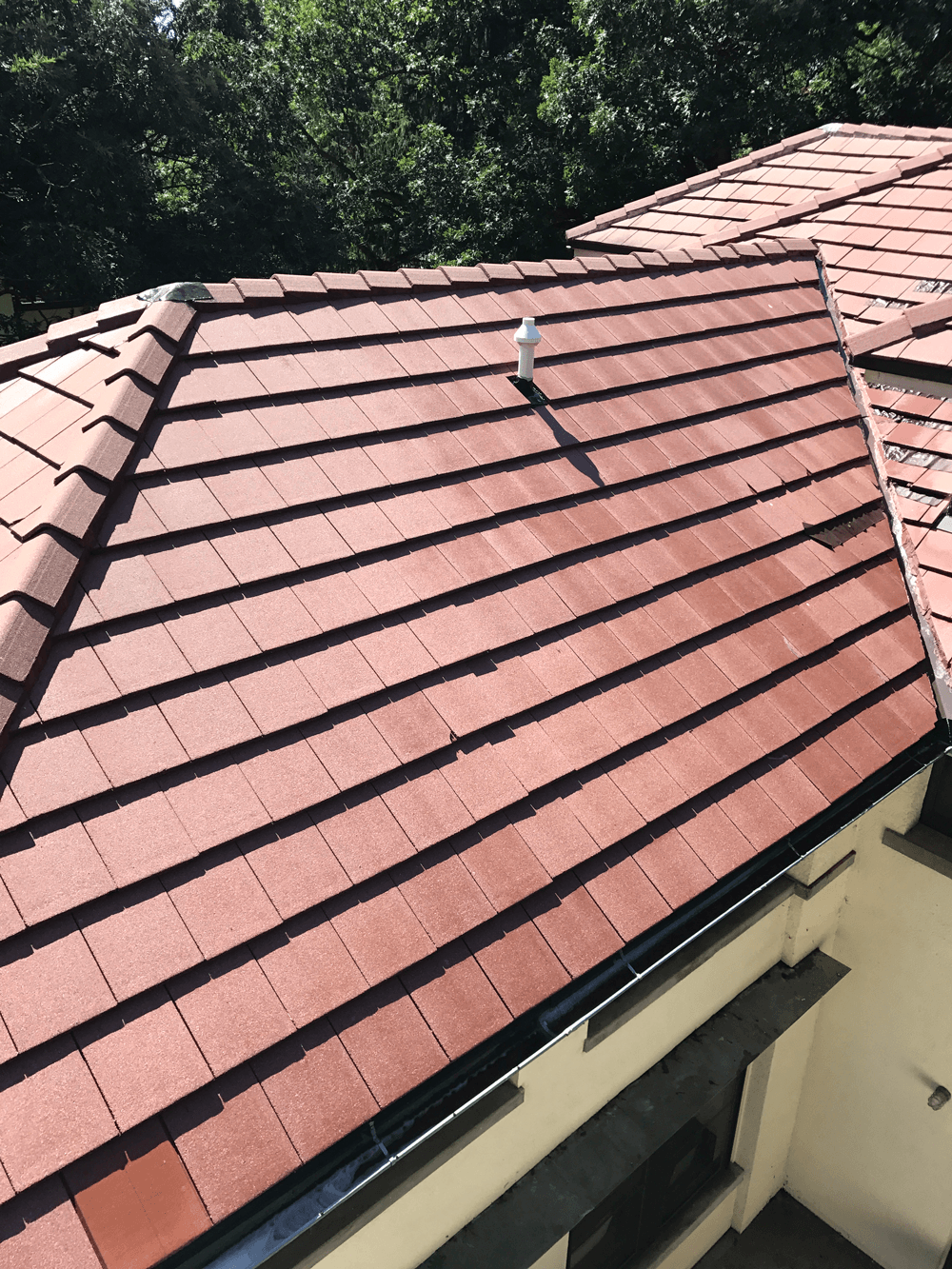 a close up of a red tile roof on a house .