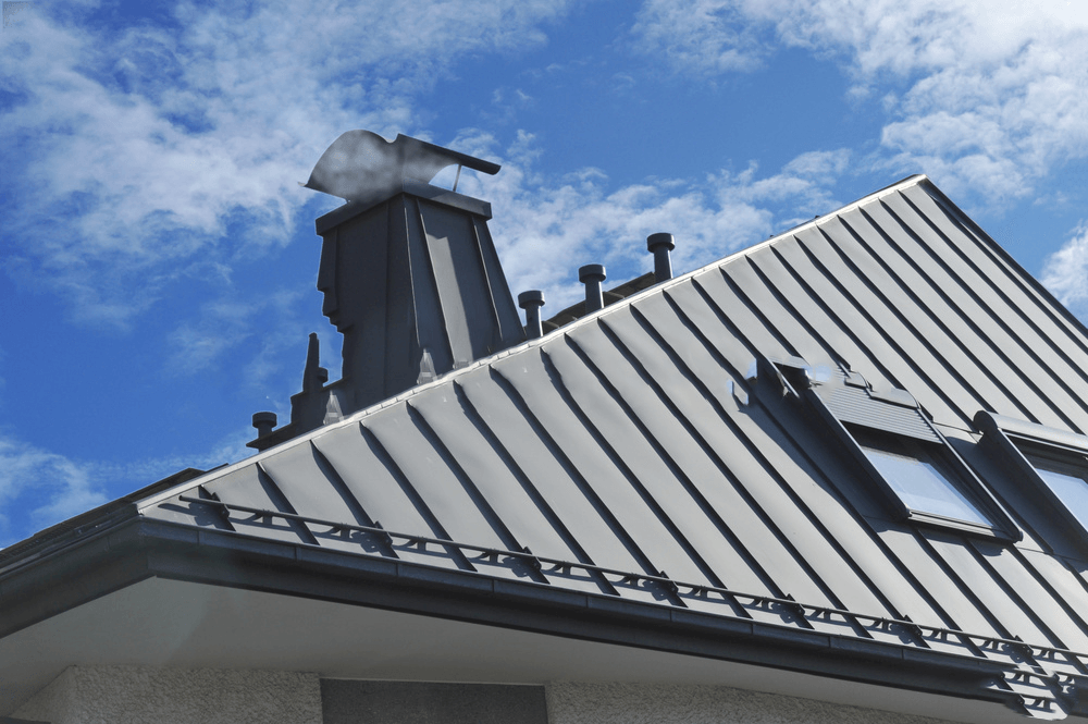 a roof with a chimney on top of it and a blue sky in the background .