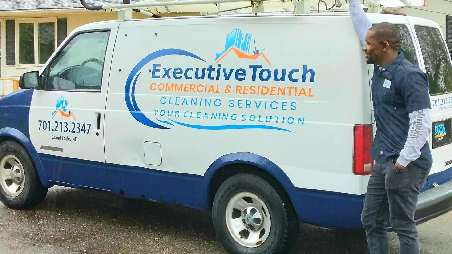 A woman is vacuuming a carpet in a living room.