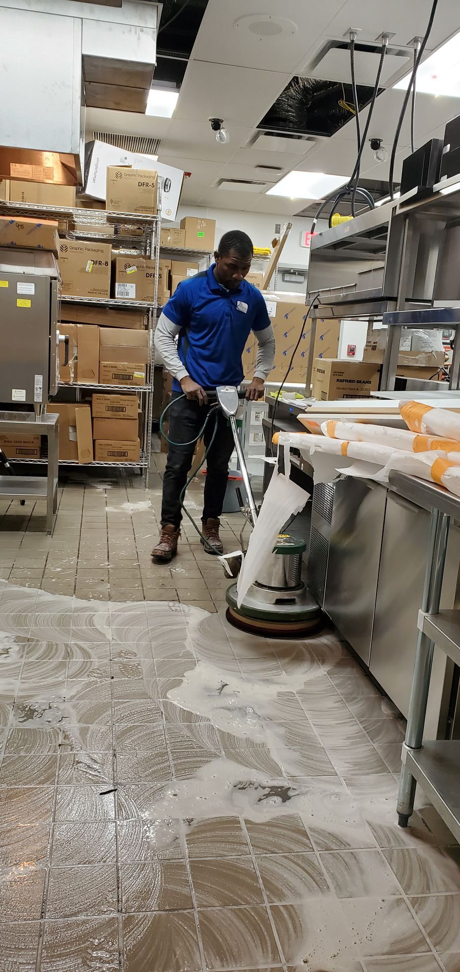 A group of construction workers are cleaning the floor of a building.