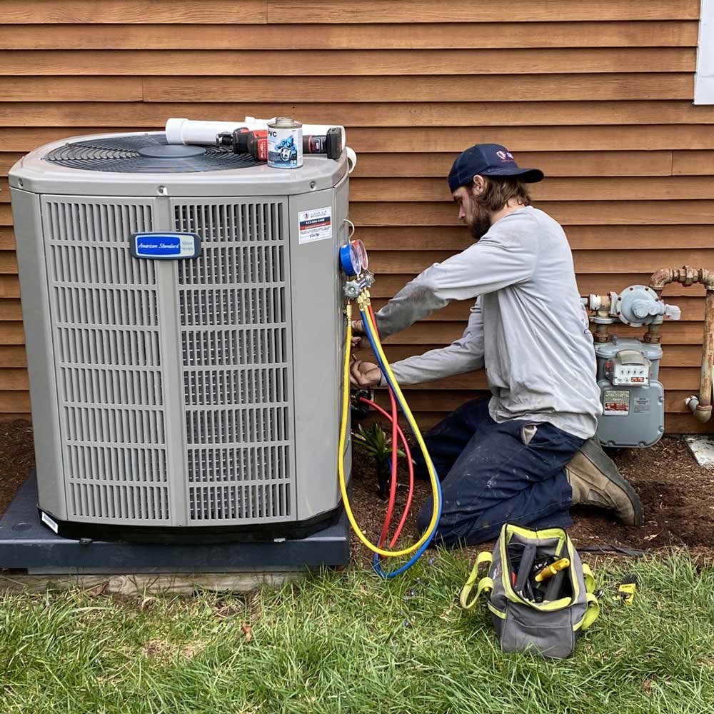 Technician Checking Heat Pump — West Springfield, MA — Clean Air Mechanical Heating & Air Conditioning