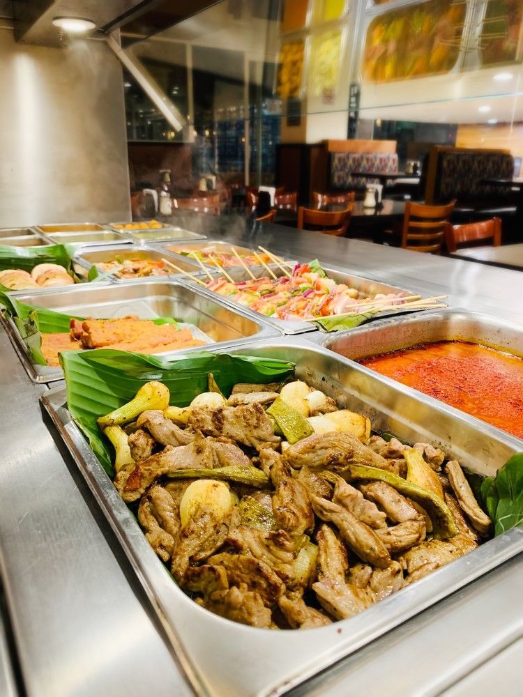 A buffet line filled with lots of different types of food