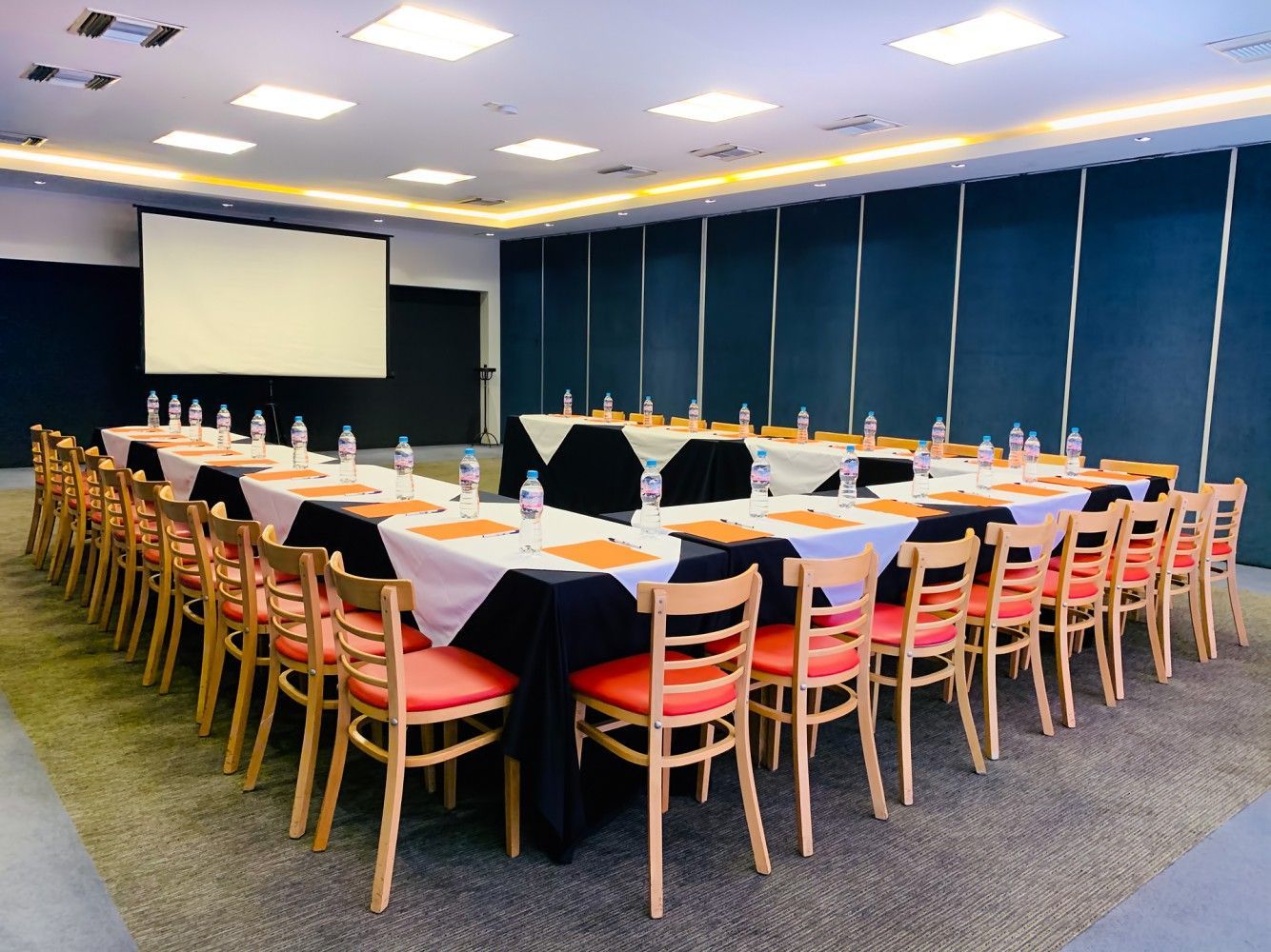 A conference room with tables and chairs set up for a meeting