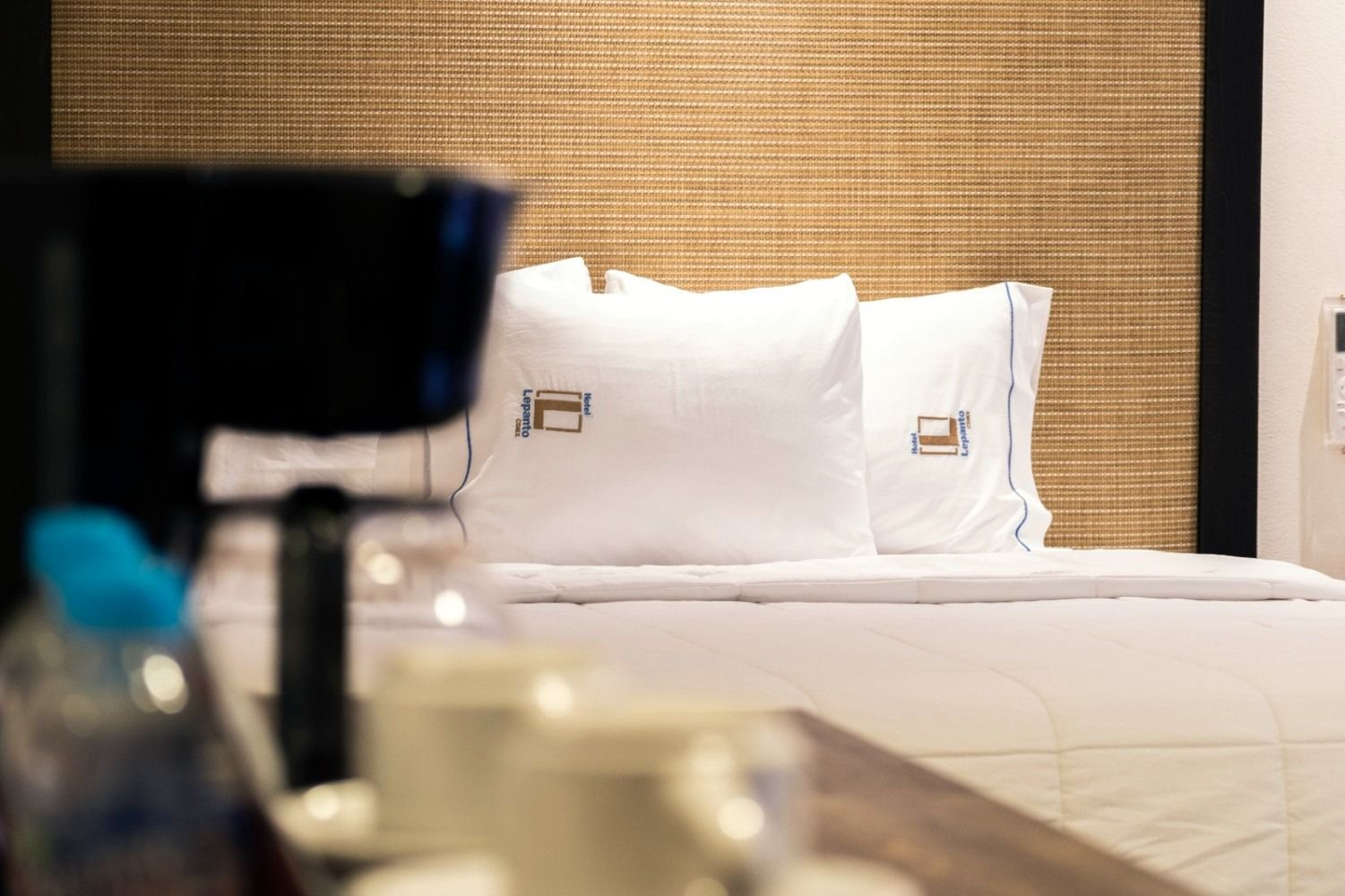 A hotel room with a bed and a coffee maker.