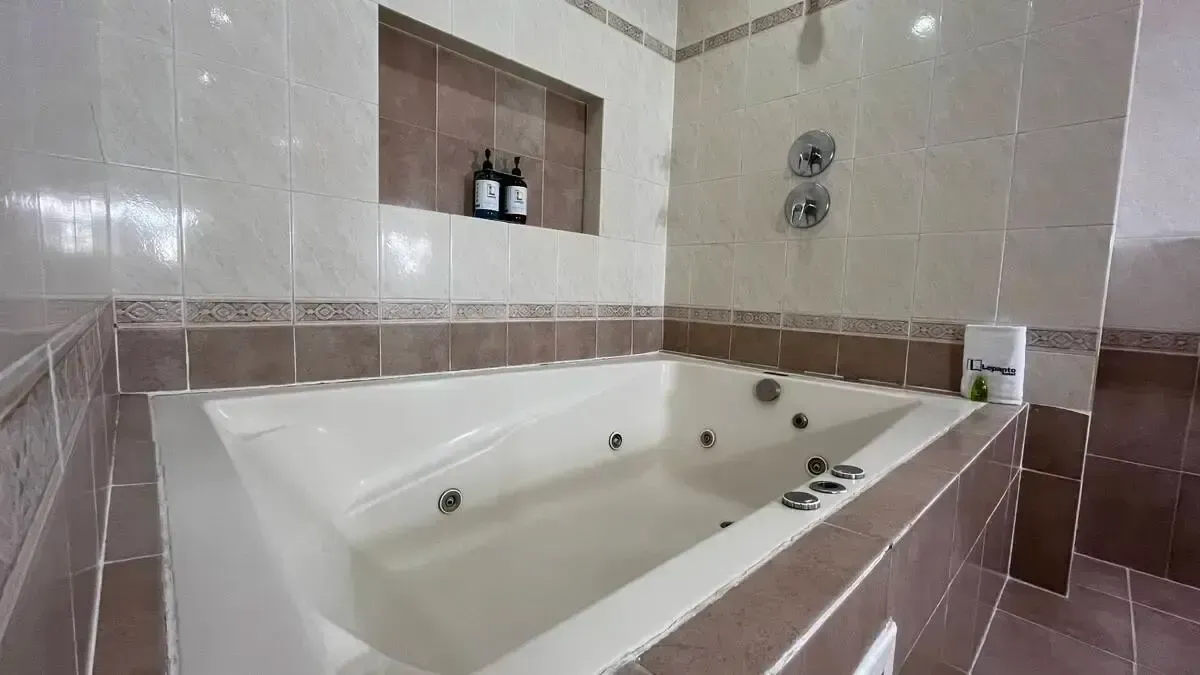 A bathroom with a jacuzzi tub and a shower.