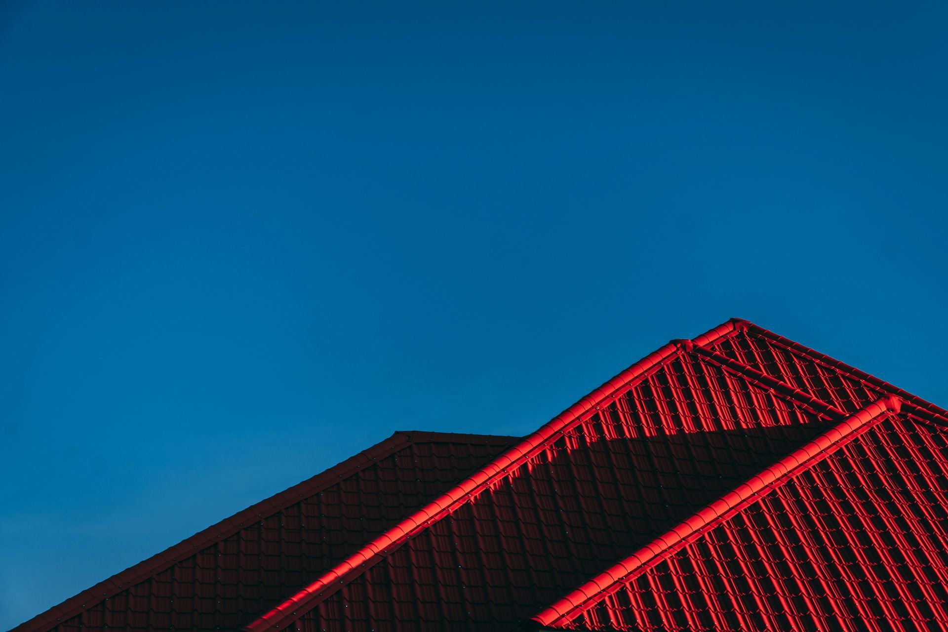 Red roof against a deep blue sky.