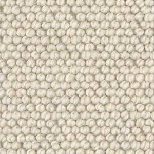 A close up of a white rug with a polka dot pattern.