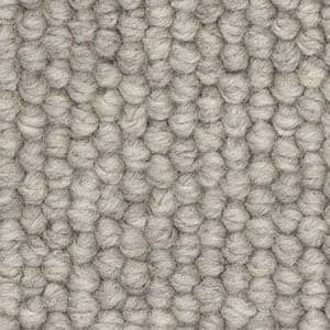 A close up of a gray carpet with a knitted pattern.