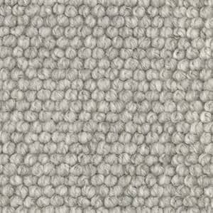 A close up of a gray rug with a polka dot pattern.