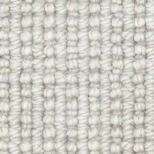 A close up of a white carpet with a knitted pattern.
