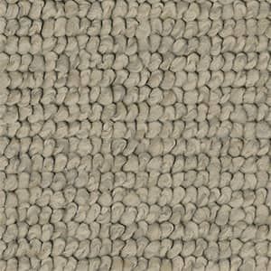 A close up of a rug with a knitted pattern.