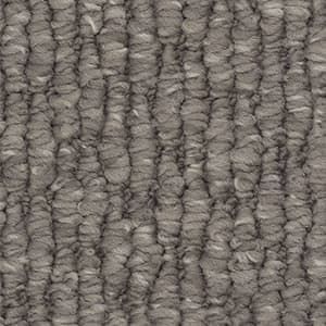 A close up of a gray carpet with a striped pattern.