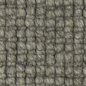 A close up of a gray rug with a knitted pattern.