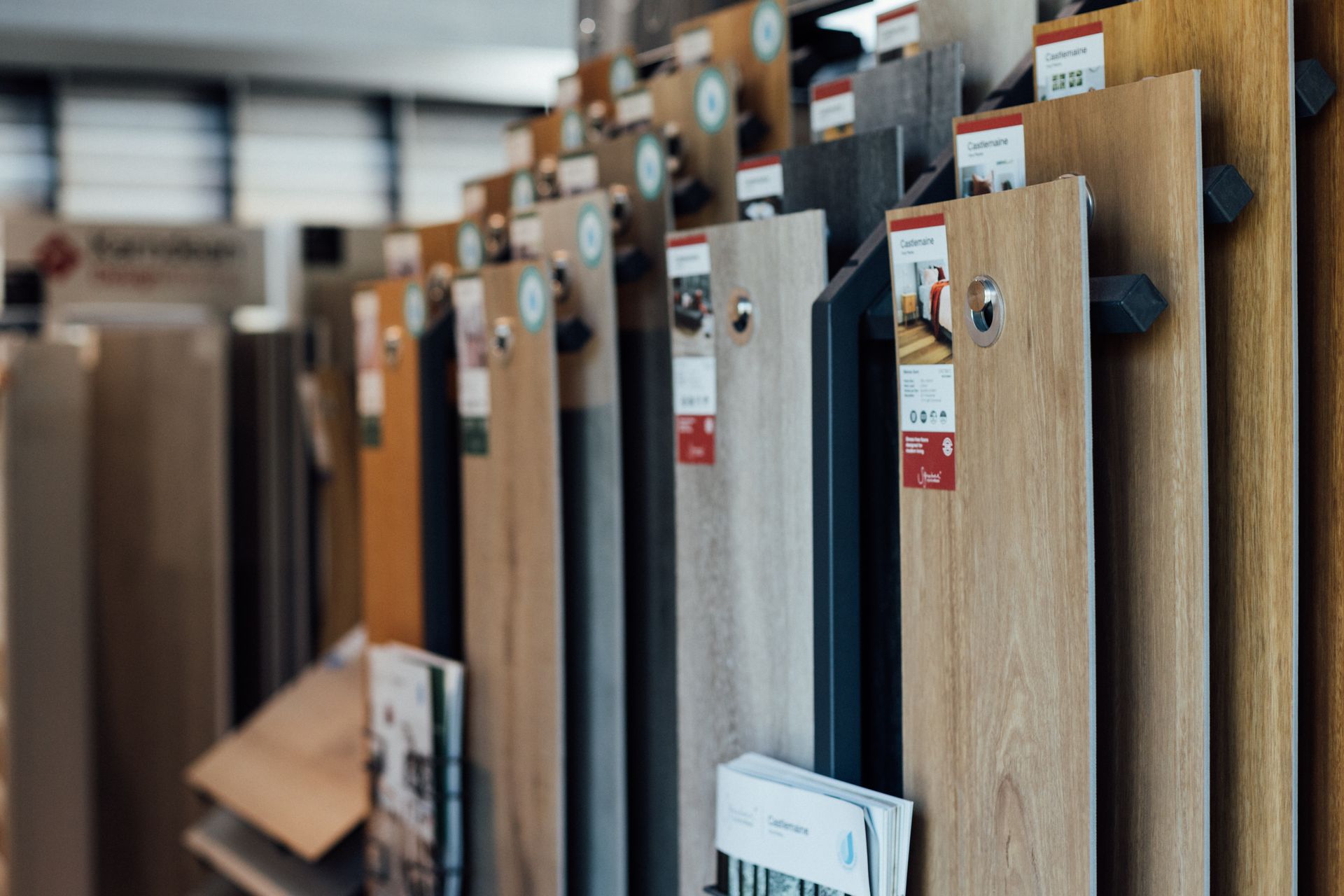 A bedroom with a bed , two windows and a painting on the wall.