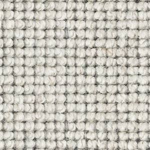 A close up of a white carpet with a checkered pattern.