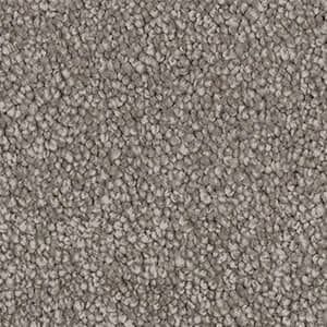 A close up of a pile of gray carpet.