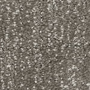 A close up of a carpet with a lot of small stones on it.