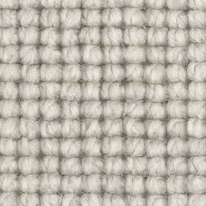 A close up of a white rug with a checkered pattern.