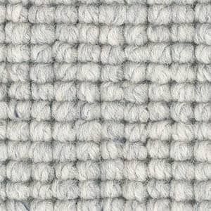 A close up of a white carpet with a knitted pattern.