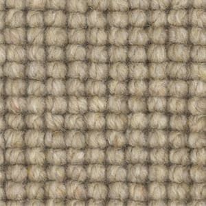 A close up of a carpet with a knitted pattern.