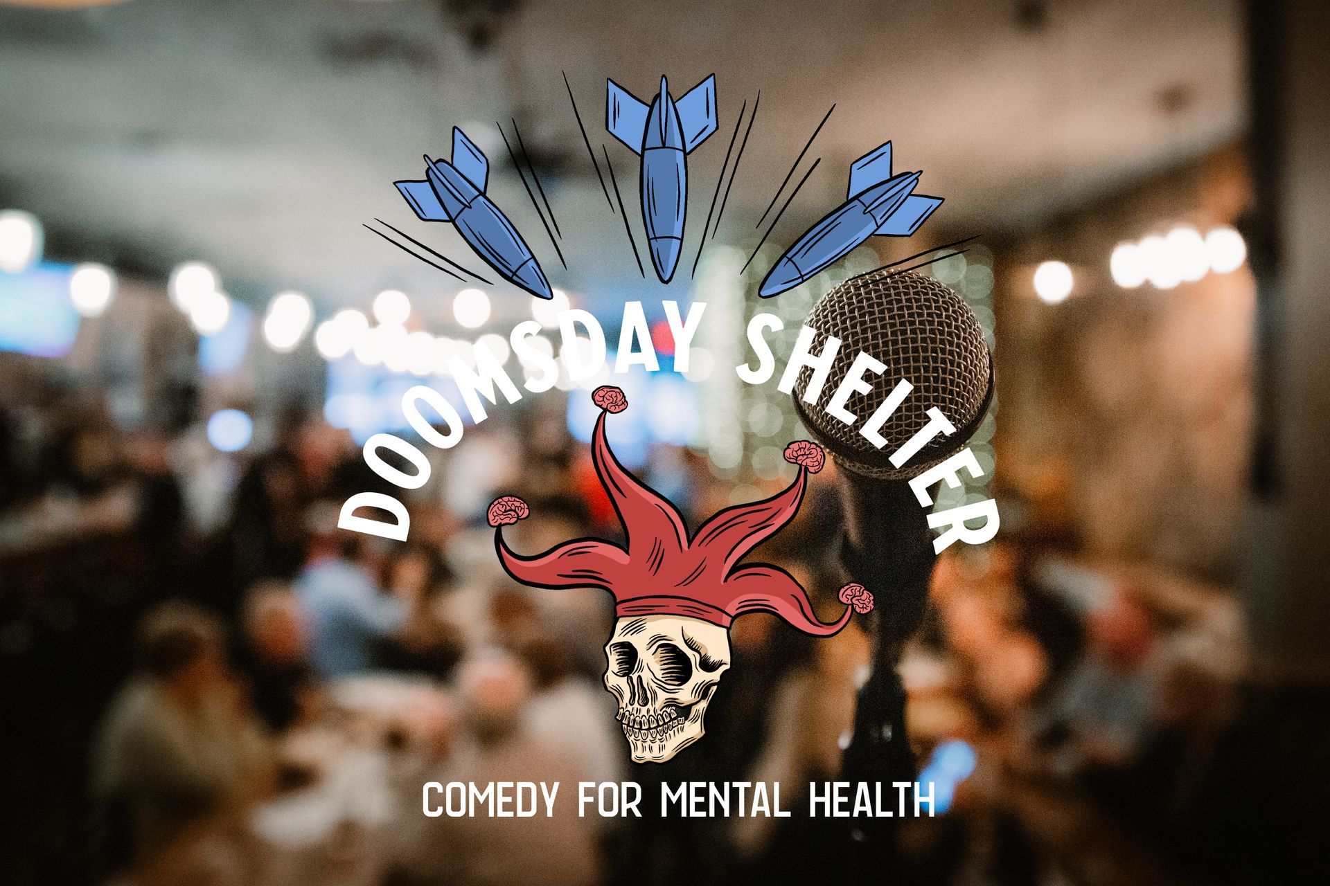 Close-up of a microphone on a stand, blurred audience in the background.