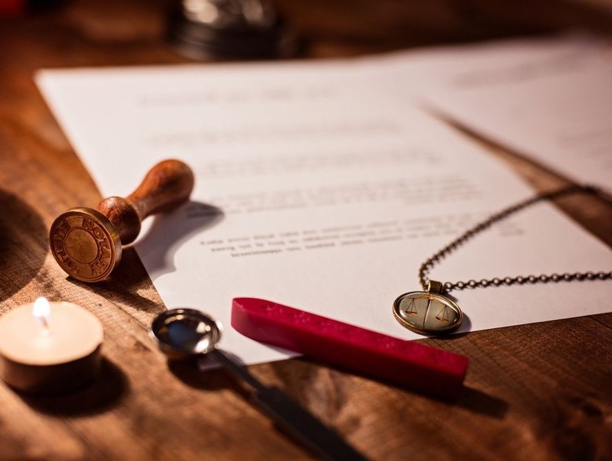 A notary stamp is sitting on top of a red ink pad