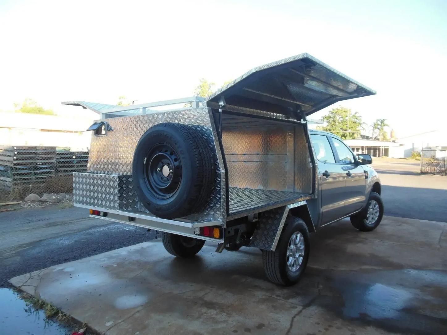 A Silver Truck with A Canopy and A Spare Tire on The Back Is Parked on The Side of The Road — MBB Toolbox In Winnellie, NT