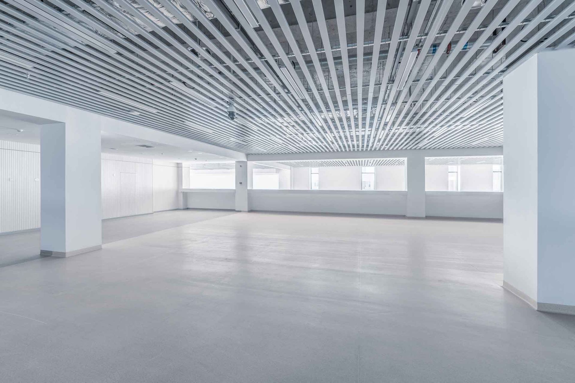 A Large Empty Room With A Striped Ceiling And A Lot Of Windows – Melbourne, VIC - Hands On Concrete Vic