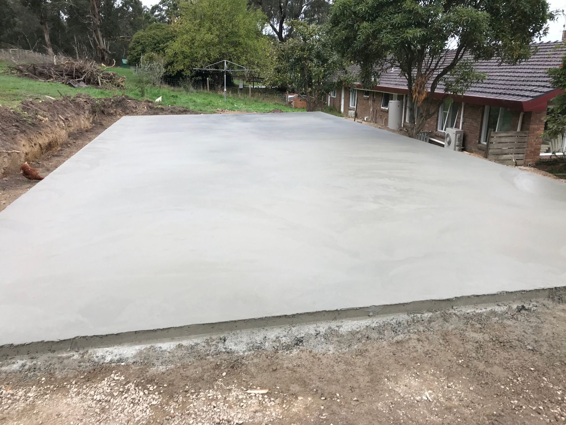 A Fence With A Blue Sky In The Background And A Green And Yellow Floor – Melbourne, VIC - Hands On Concrete Vic
