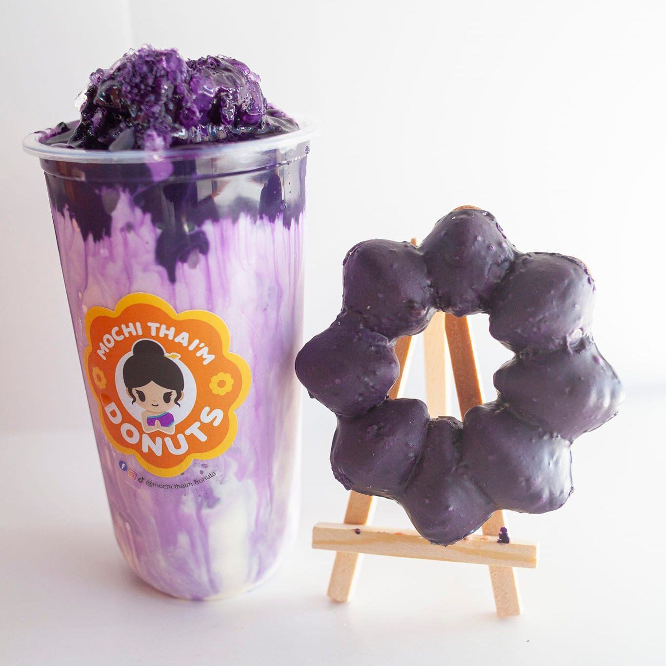 a cup of mochi that 's donuts next to a donut