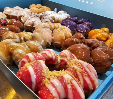 a box filled with a variety of donuts in different flavors
