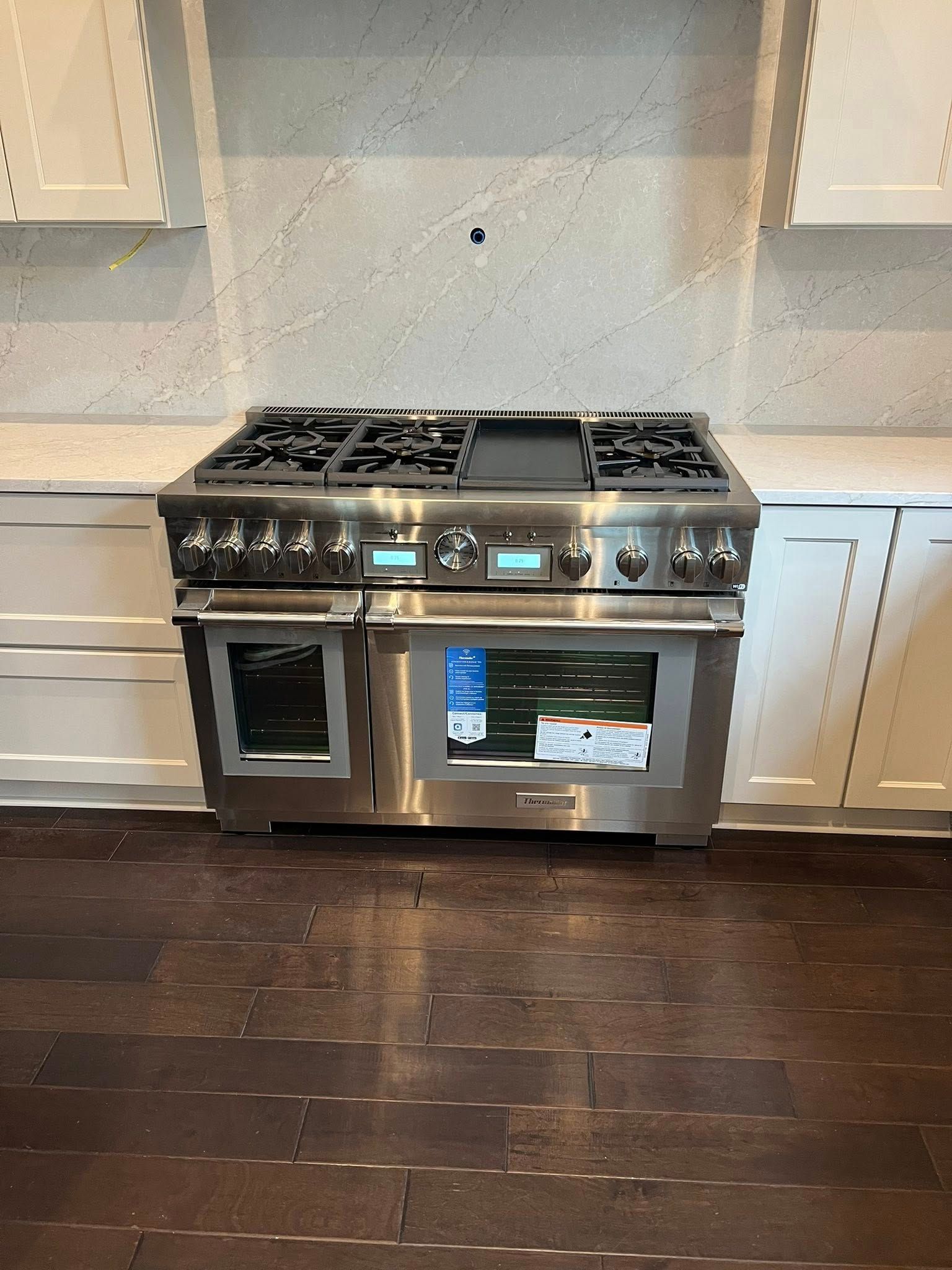 Stainless steel professional range oven in a kitchen.