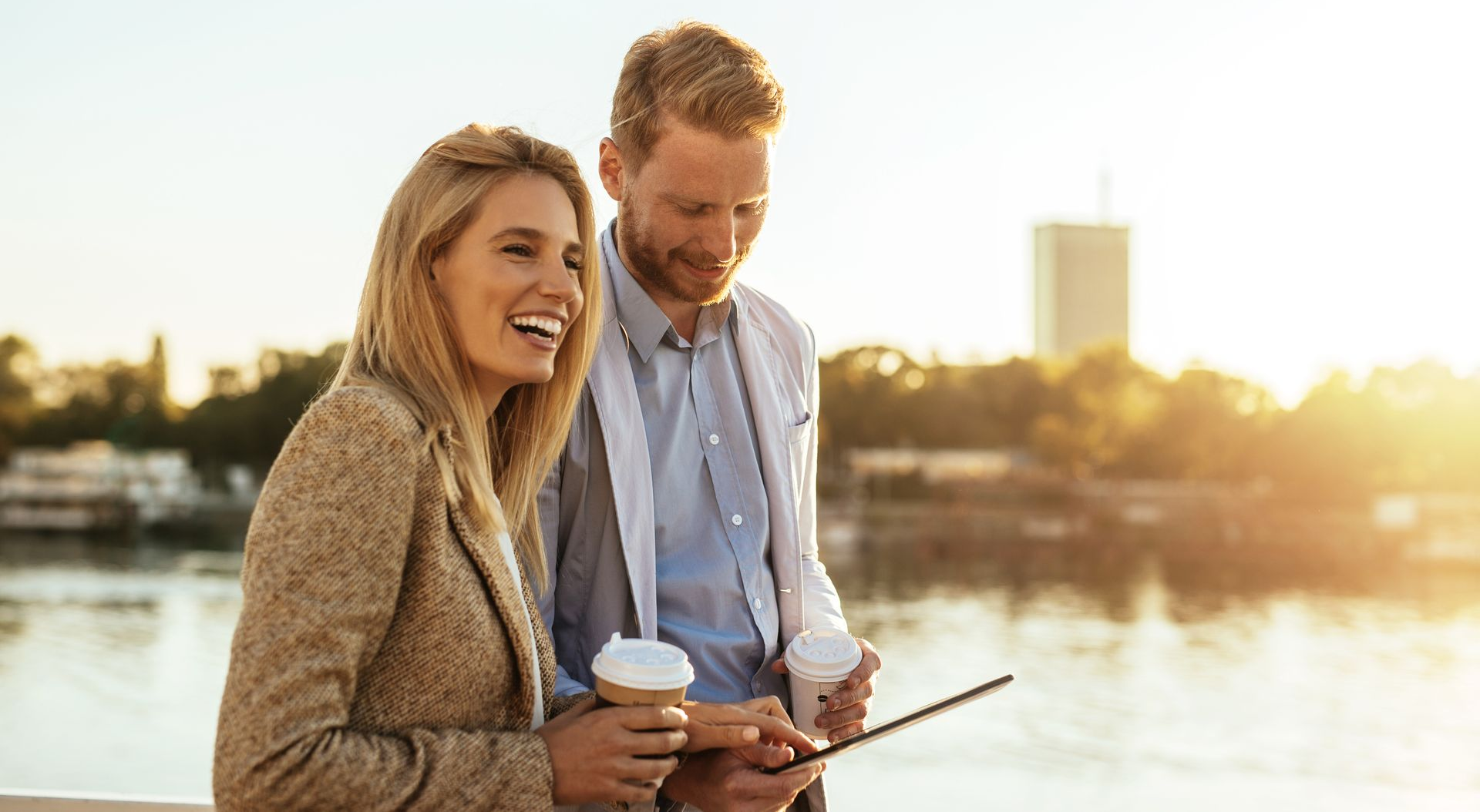 Stock photo of a couple, smiling with drinks in hand
