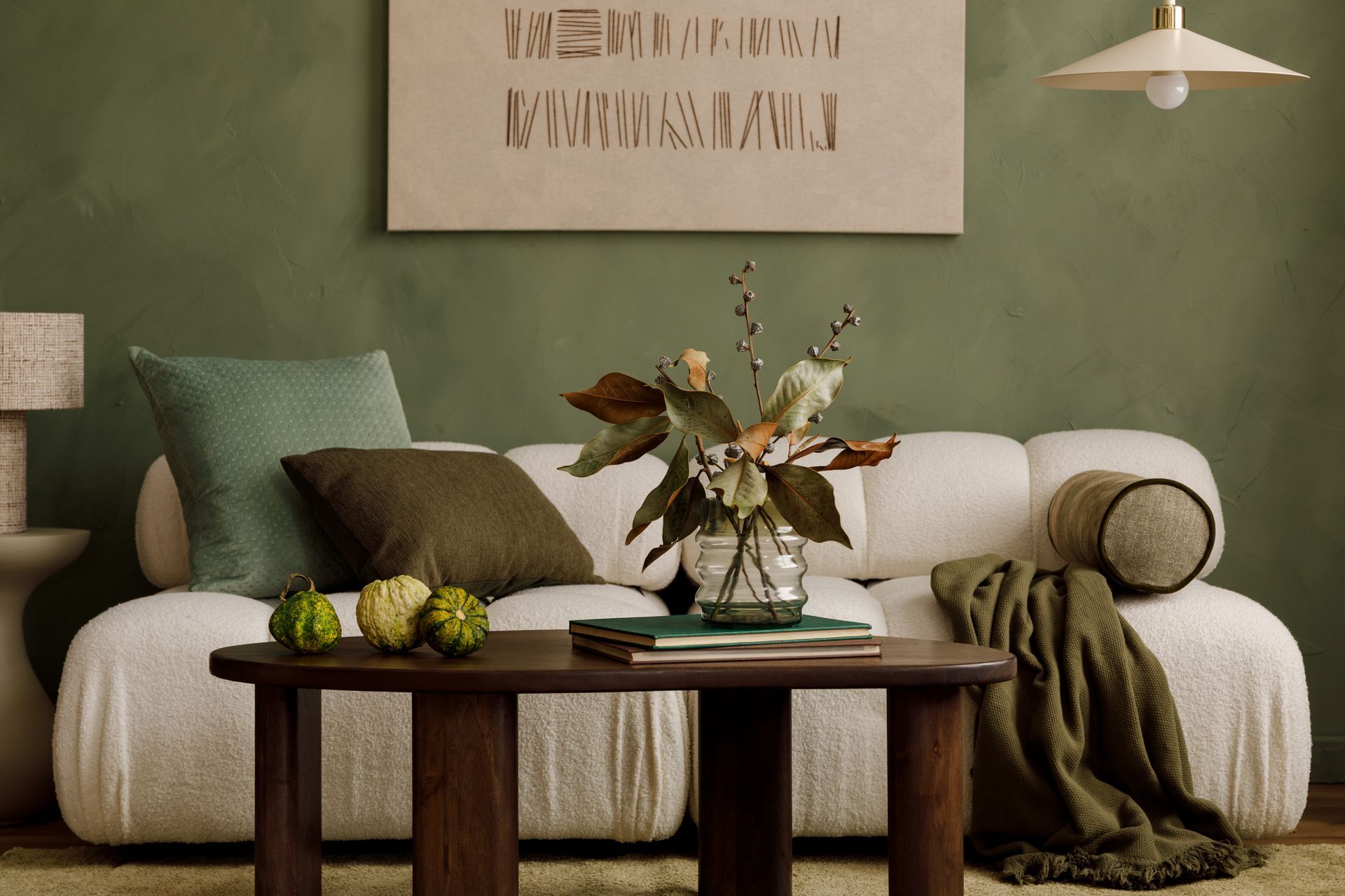 Stock photo of a couch with a table in front of it, and an assortment of books, table nick-nacks and more