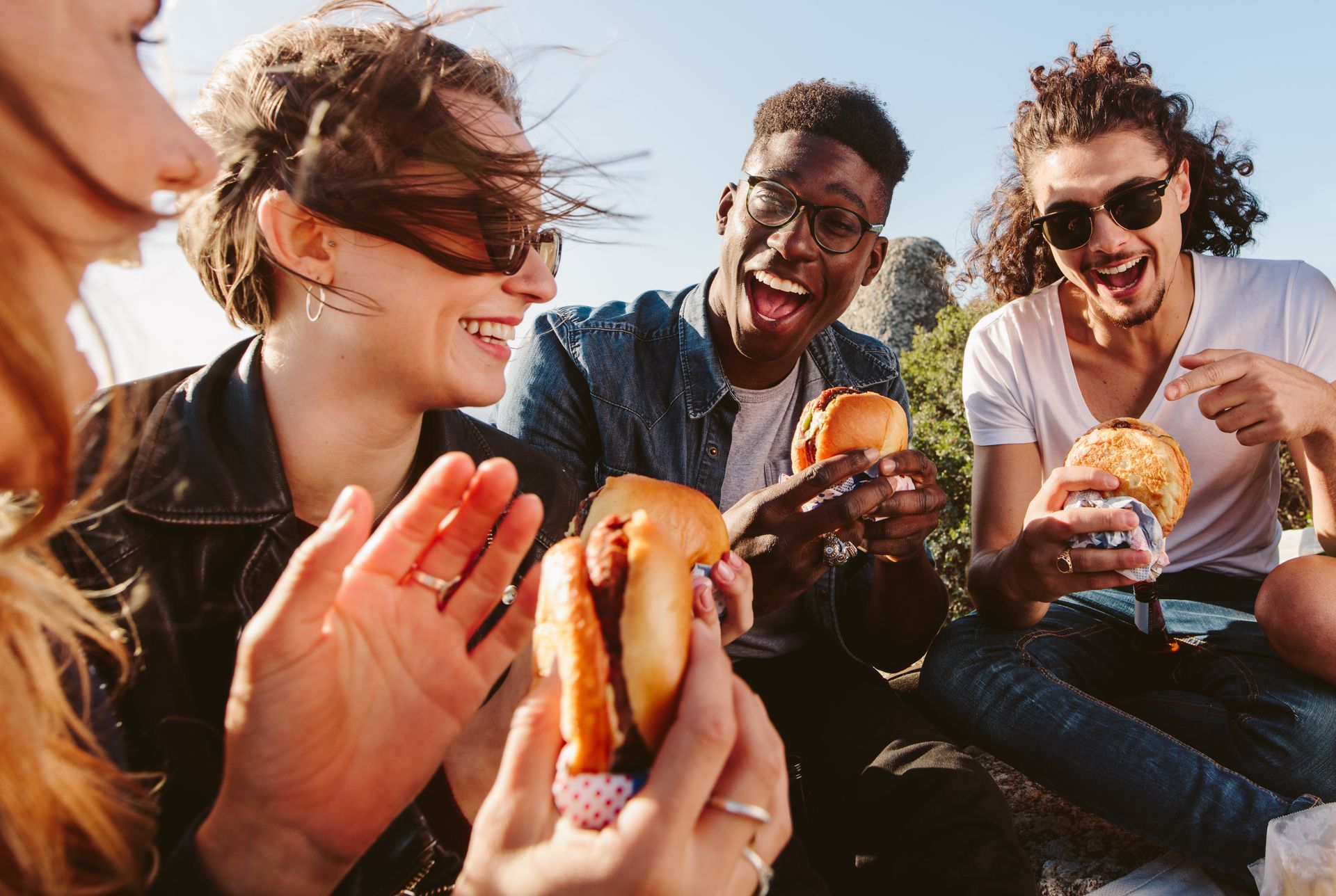 Stock photo of a group of people eating burgers