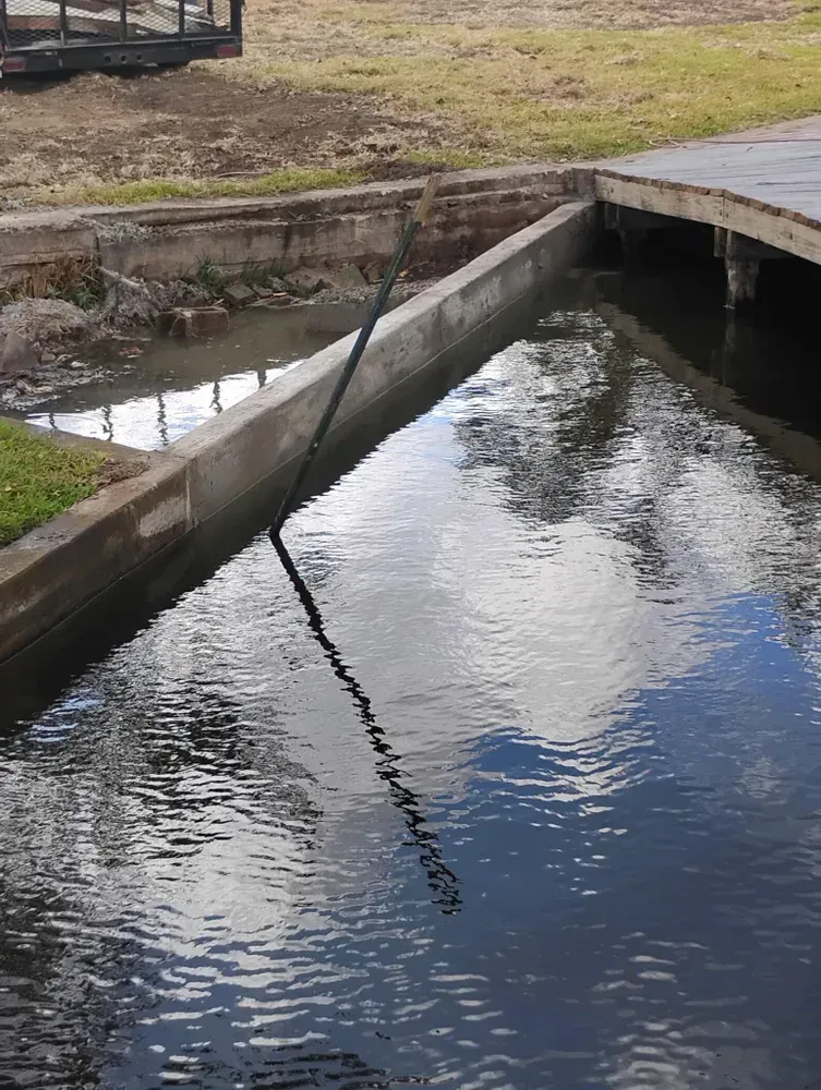 A large body of water with a bridge in the background