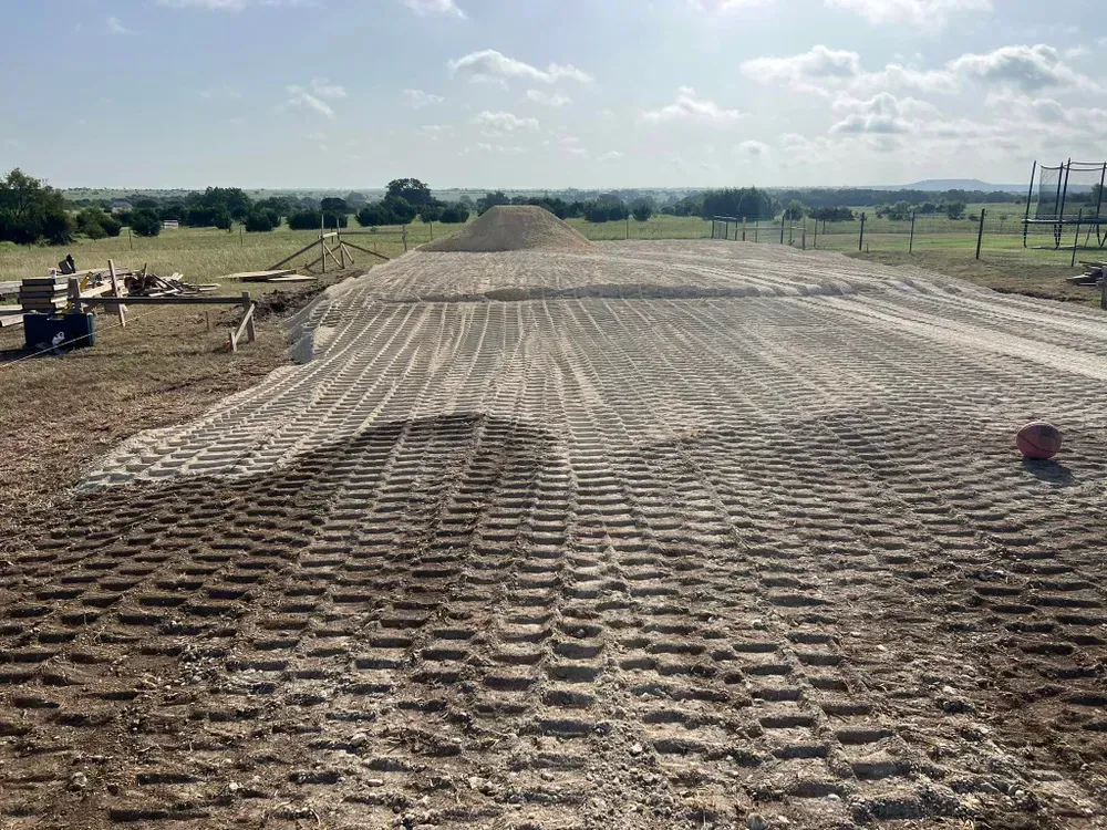 A dirt road with a lot of tire tracks on it.