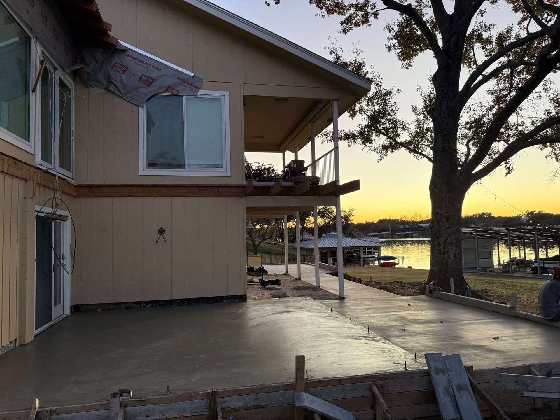 A house is being built next to a body of water.