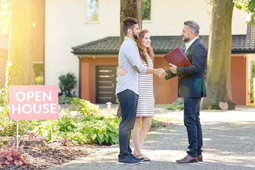 New Home Construction — Real Estate Agent Welcoming the Couple in Montgomery, AL