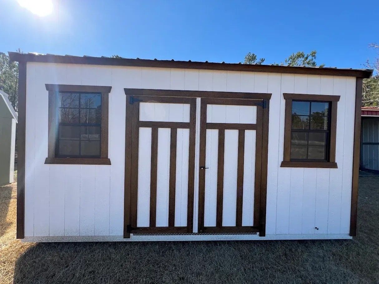 A white building with a wooden door and windows