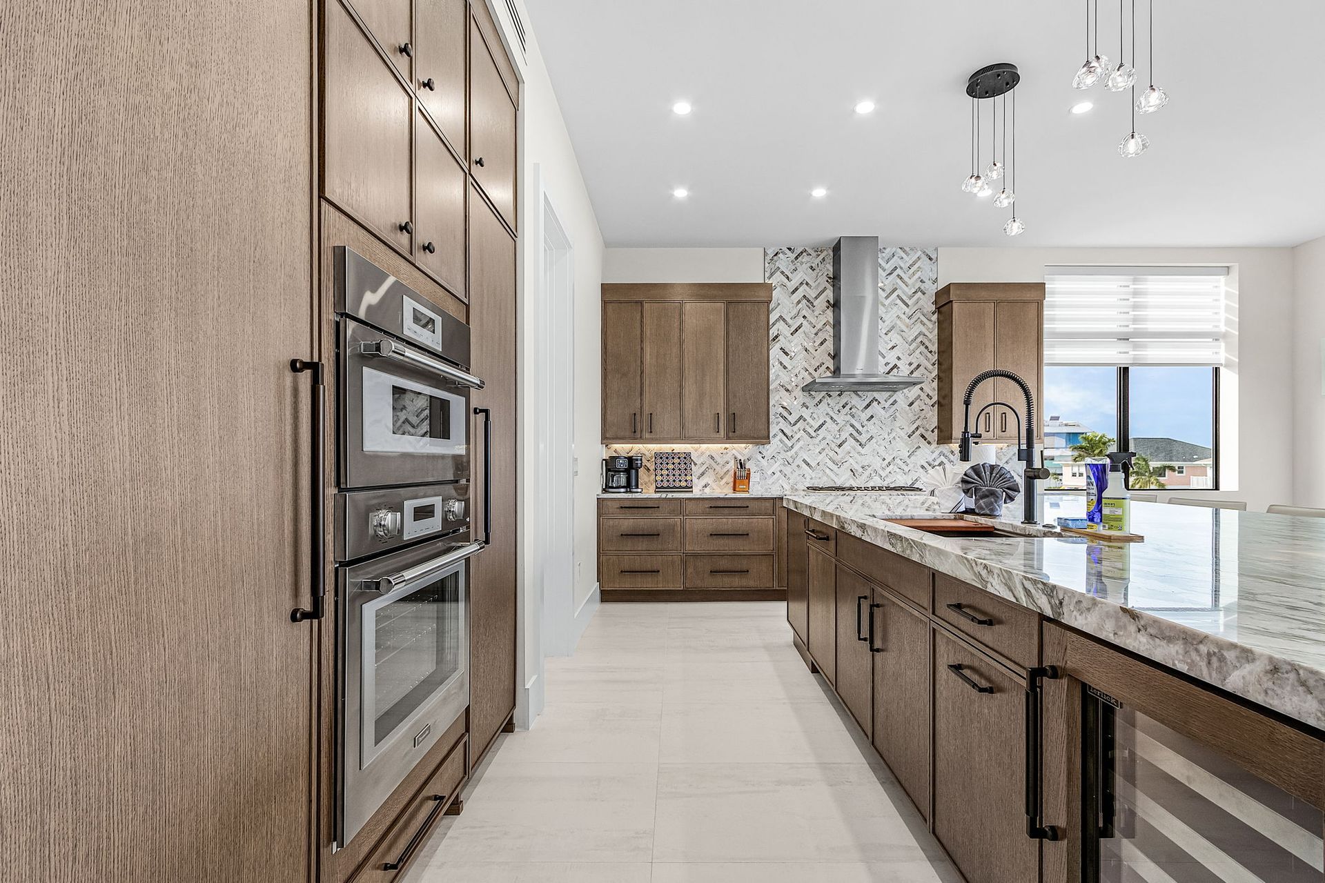 Modern kitchen with wood cabinets, granite countertops, and stainless steel appliances.