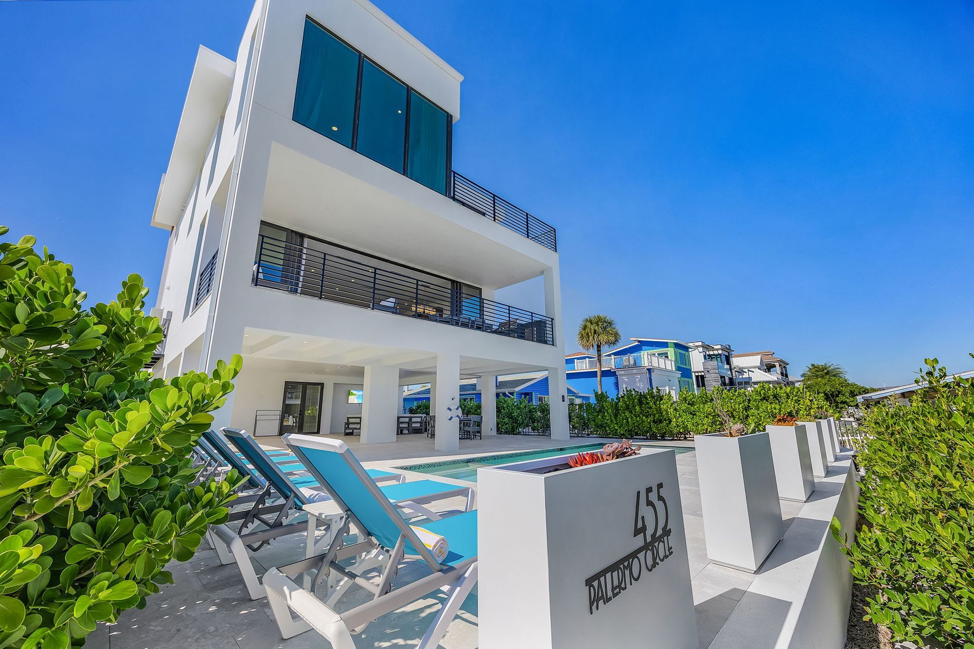 Modern white house with a pool and ocean view.