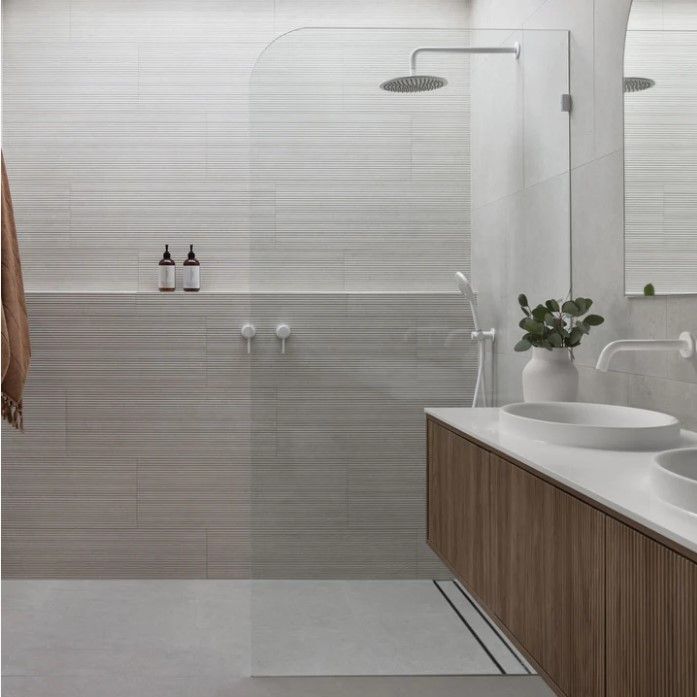 walk-in shower with grey and brown tiles