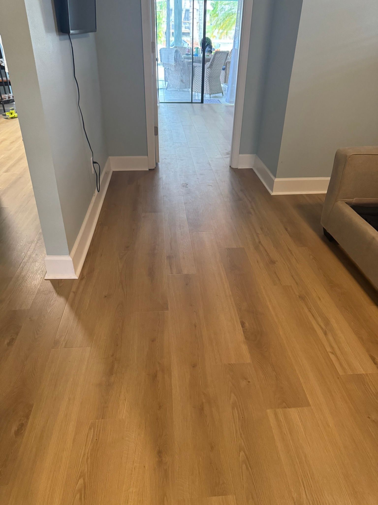 A living room with hardwood floors and a couch.