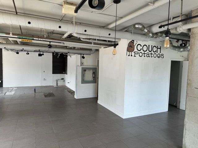 An empty room with a sign that says couch potatoes.