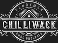 A logo featuring a worker wearing a hard hat and holding a hammer inside a shield, next to the text 