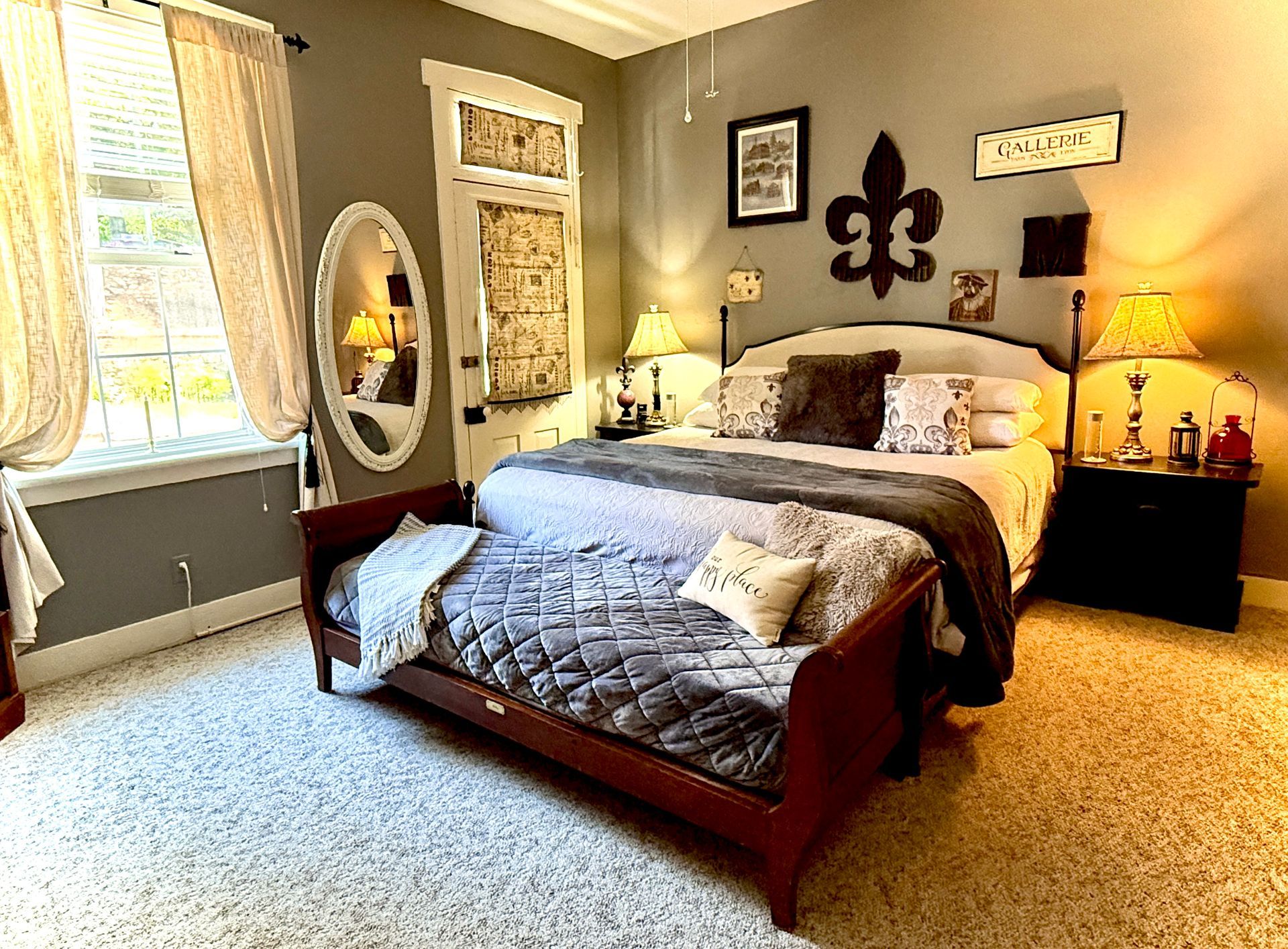 Bedroom with bed, dog bed, gray walls, white trim, and a window with curtains.